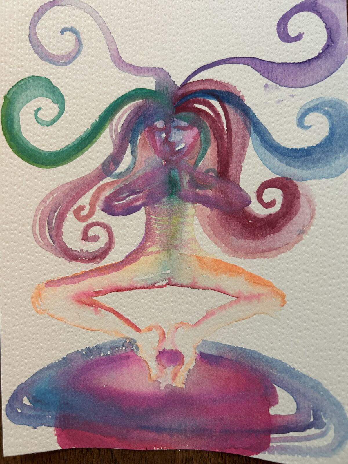 Watercolor of a seated meditating figure with colorful hair-like energy spiraling outward in green, purple, and pink